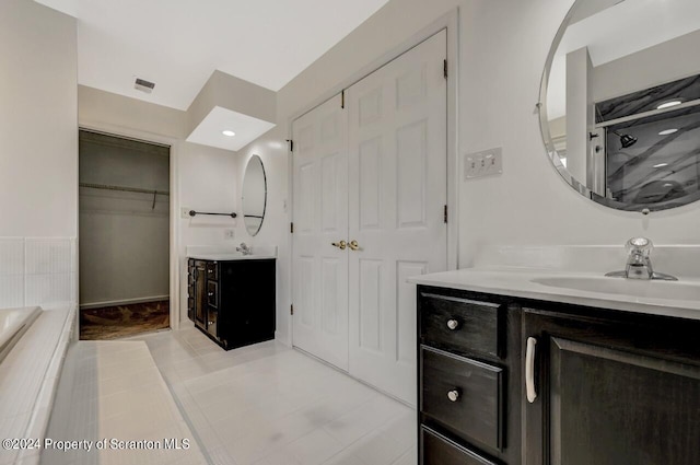 bathroom featuring tile patterned flooring and vanity