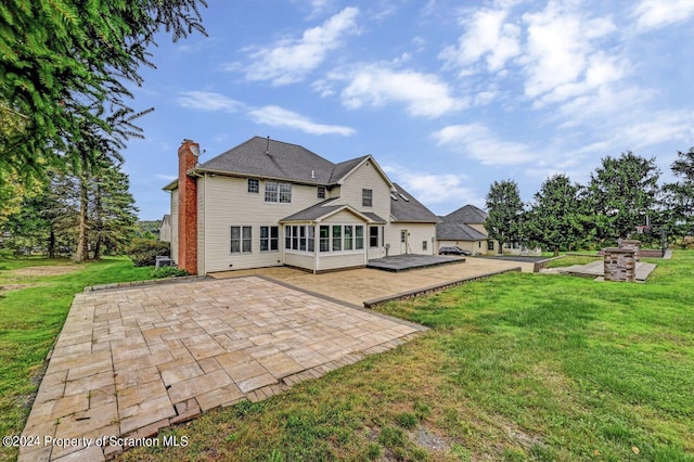 back of house featuring a yard and a patio