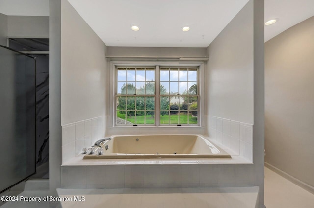 bathroom with tiled bath