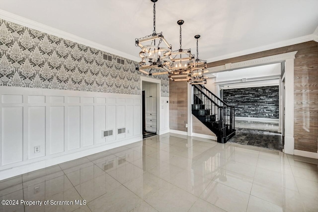 unfurnished room with a chandelier and ornamental molding