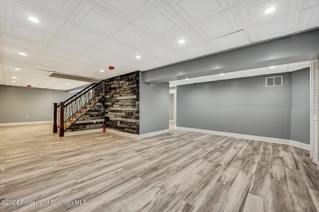 basement with light hardwood / wood-style flooring