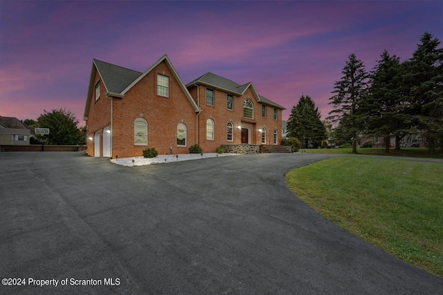 view of front of house with a lawn and a garage