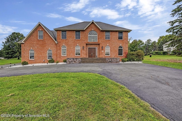 105 Crossgate Dr, South Abington Twp, PA 18411 - view of front facade with brick siding, a front yard, and asphalt driveway