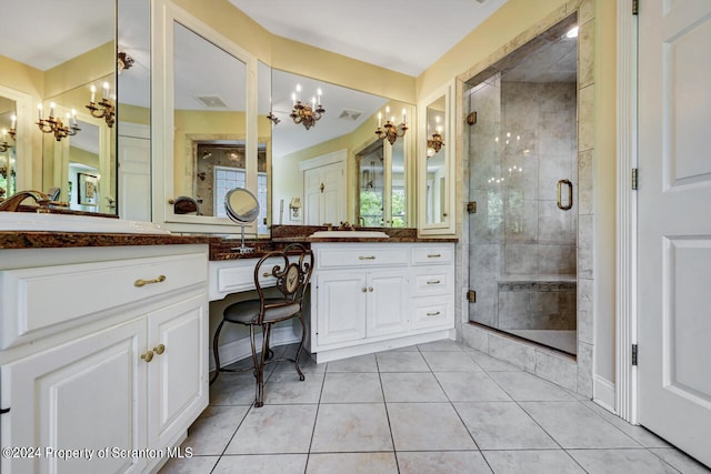 bathroom featuring tile patterned flooring, vanity, and a shower with door