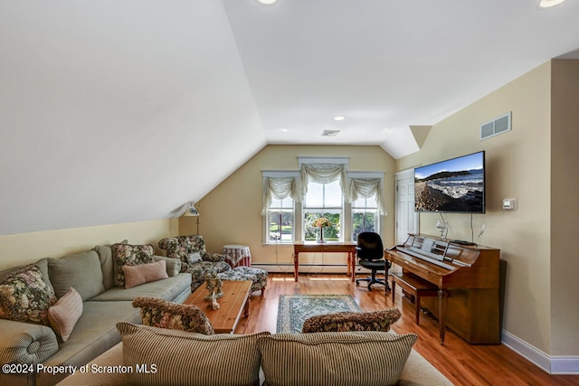 living room featuring hardwood / wood-style flooring, baseboard heating, and lofted ceiling