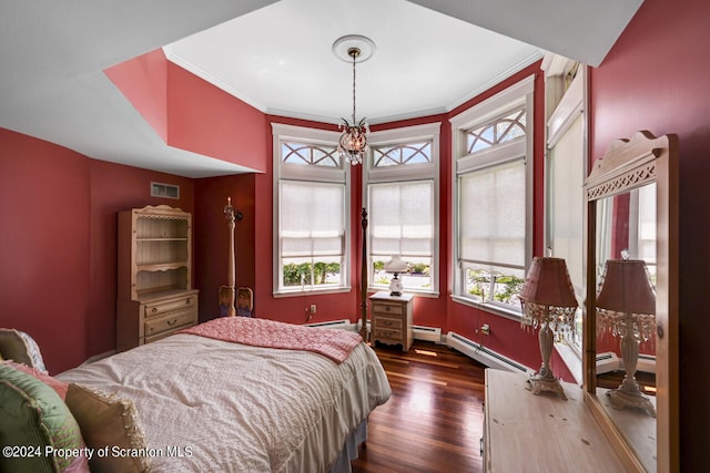 bedroom featuring baseboard heating, dark hardwood / wood-style flooring, an inviting chandelier, and ornamental molding