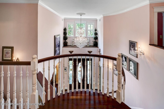 staircase with a notable chandelier and crown molding