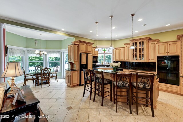 kitchen with pendant lighting, backsplash, black appliances, a wealth of natural light, and a kitchen island