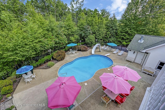 view of swimming pool featuring a patio area and a water slide