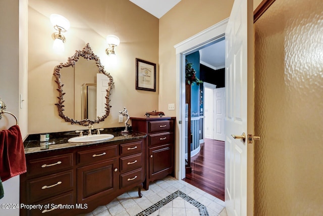 bathroom with tile patterned flooring, vanity, and crown molding