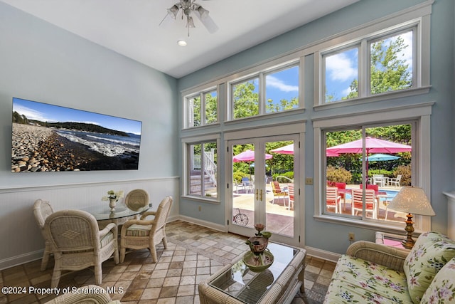 interior space with ceiling fan and french doors