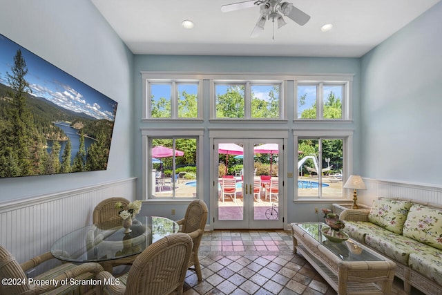 living room featuring tile patterned floors, ceiling fan, plenty of natural light, and french doors