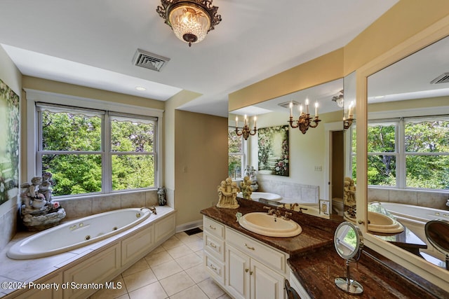 bathroom featuring tile patterned floors, vanity, a wealth of natural light, and an inviting chandelier