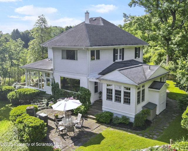 218 Weatherby St, Dalton, PA 18414 - rear view of house featuring a chimney, a patio area, roof with shingles, and a yard