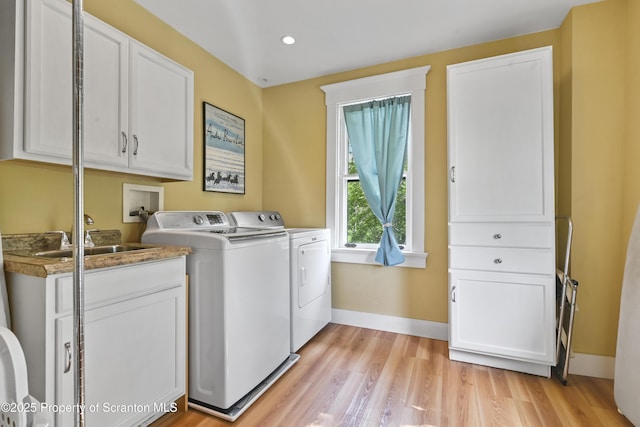 218 Weatherby St, Dalton, PA 18414 - laundry area featuring a sink, cabinet space, light wood-type flooring, washing machine and dryer, and baseboards