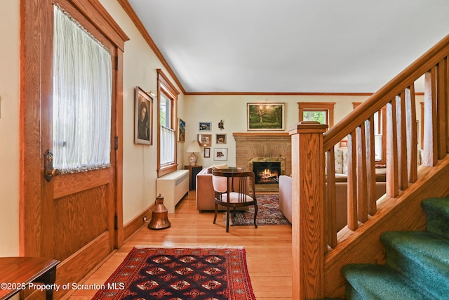 218 Weatherby St, Dalton, PA 18414 - entryway featuring stairs, wood finished floors, a brick fireplace, crown molding, and radiator