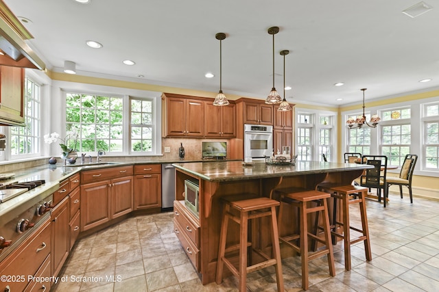 218 Weatherby St, Dalton, PA 18414 - kitchen featuring a wealth of natural light, stainless steel appliances, brown cabinets, and ornamental molding