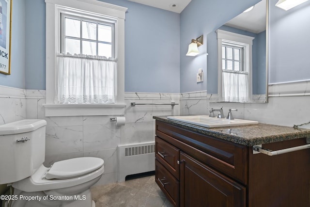 218 Weatherby St, Dalton, PA 18414 - bathroom with tile walls, radiator, wainscoting, toilet, and vanity