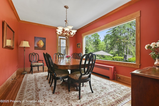 218 Weatherby St, Dalton, PA 18414 - dining room featuring wood finished floors, radiator, a notable chandelier, crown molding, and baseboards
