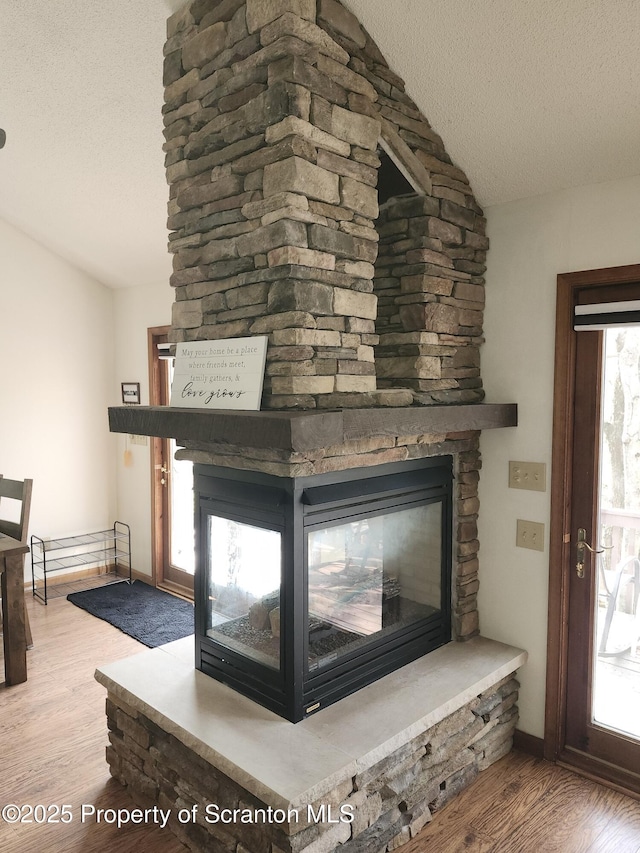 2258 Northgate Ct S Unit 16, Lake Ariel, PA 18436 - details with baseboards, a textured ceiling, wood finished floors, and a fireplace