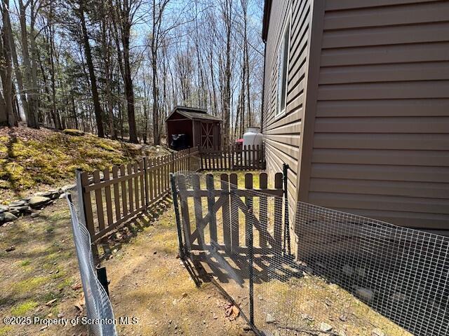 2258 Northgate Ct S Unit 16, Lake Ariel, PA 18436 - exterior space featuring an outdoor structure, fence, and a shed