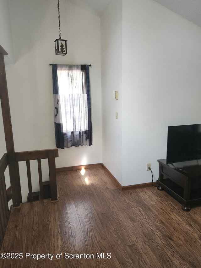 2258 Northgate Ct S Unit 16, Lake Ariel, PA 18436 - unfurnished living room featuring wood finished floors, baseboards, and lofted ceiling