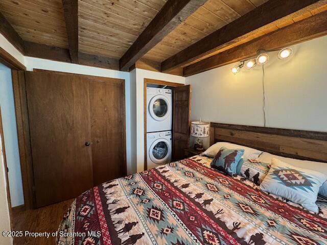 2258 Northgate Ct S Unit 16, Lake Ariel, PA 18436 - bedroom featuring stacked washer / drying machine, wood ceiling, beam ceiling, and wood finished floors