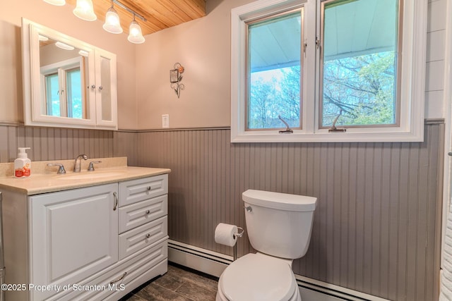 144 Crosstown Hwy, Union Dale, PA 18470 - half bath with a baseboard heating unit, wainscoting, vanity, and wooden ceiling