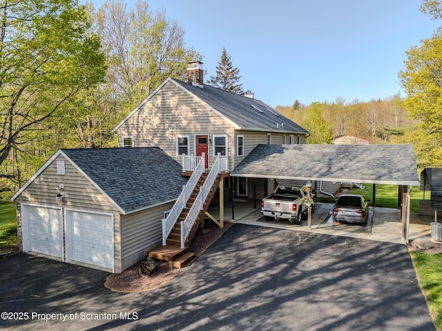 144 Crosstown Hwy, Union Dale, PA 18470 - view of front facade with a garage, a chimney, a carport, and stairs