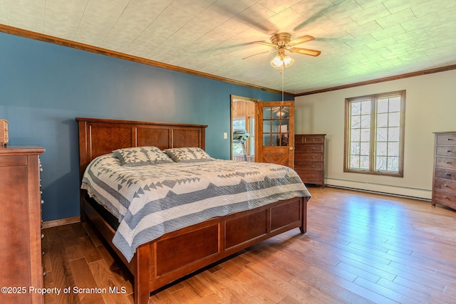 144 Crosstown Hwy, Union Dale, PA 18470 - bedroom with a baseboard radiator, crown molding, wood finished floors, and ceiling fan
