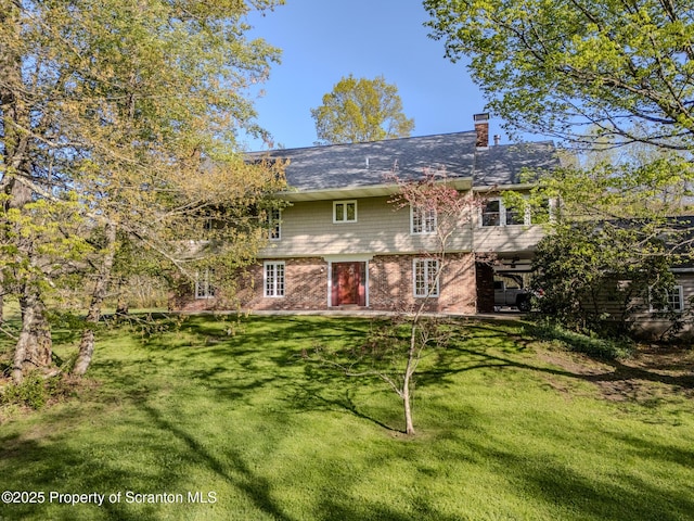 144 Crosstown Hwy, Union Dale, PA 18470 - rear view of property with a yard, brick siding, and a chimney