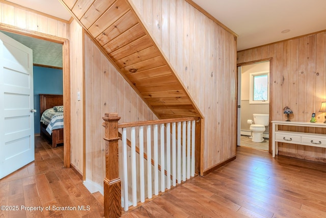 144 Crosstown Hwy, Union Dale, PA 18470 - corridor with an upstairs landing, hardwood / wood-style floors, wooden walls, and a baseboard heating unit