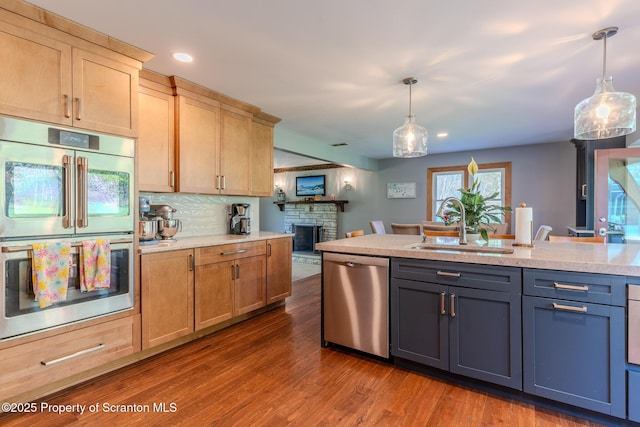 144 Crosstown Hwy, Union Dale, PA 18470 - kitchen featuring appliances with stainless steel finishes, a stone fireplace, recessed lighting, pendant lighting, and dark wood finished floors