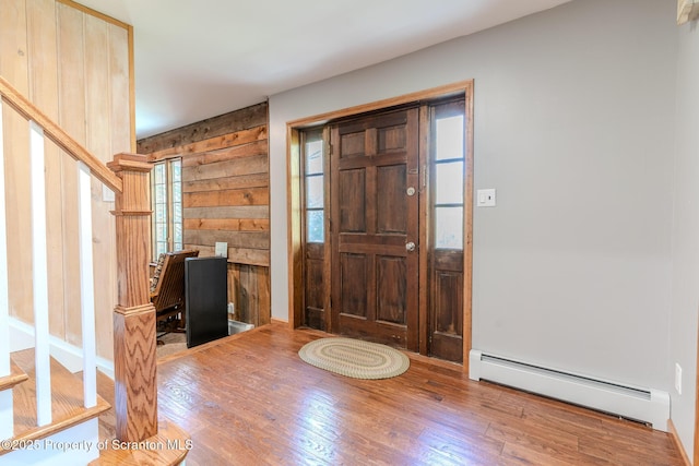 144 Crosstown Hwy, Union Dale, PA 18470 - entryway with baseboard heating, wood finished floors, wood walls, and stairs