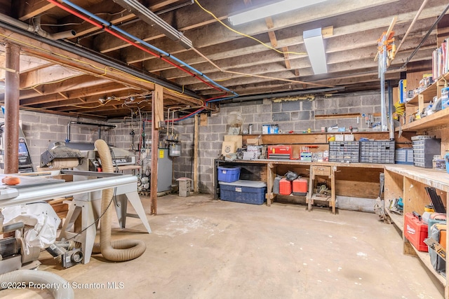 144 Crosstown Hwy, Union Dale, PA 18470 - unfinished below grade area with a workshop area, water heater, and concrete block wall