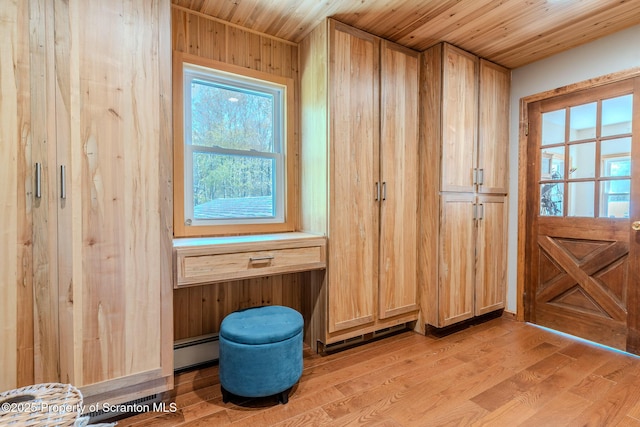 144 Crosstown Hwy, Union Dale, PA 18470 - doorway with a baseboard heating unit, light wood-style flooring, wood ceiling, and wood walls