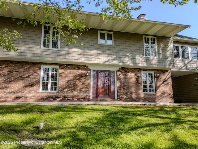 144 Crosstown Hwy, Union Dale, PA 18470 - view of front of property with a front yard, a chimney, and brick siding