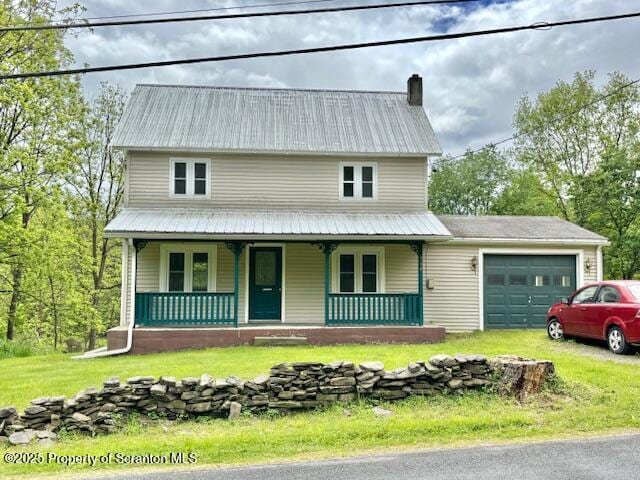 364 Briar Ridge Rd, Meshoppen, PA 18630 - view of front of home with an attached garage, metal roof, a porch, a chimney, and a front lawn