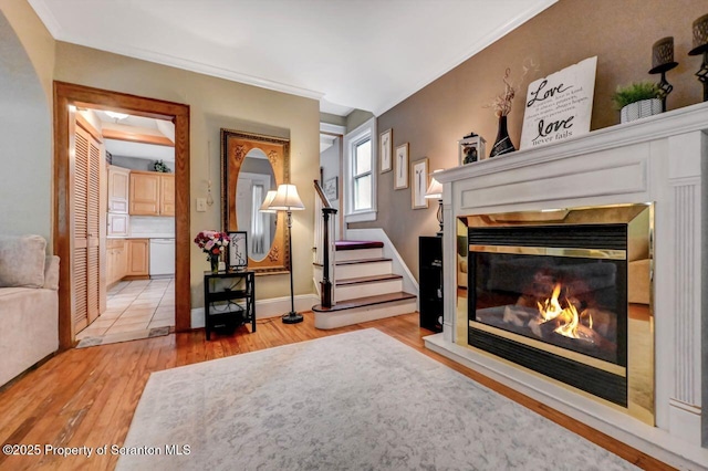 1120 Woodlawn St Unit L10, Scranton, PA 18509 - living area featuring wood finished floors, a glass covered fireplace, baseboards, and stairs