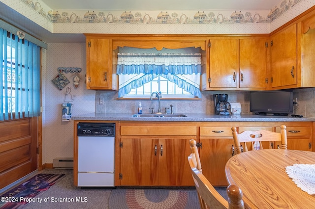 kitchen with tasteful backsplash, dishwasher, sink, and a baseboard radiator