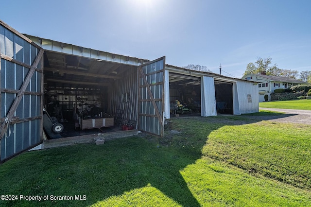 view of outbuilding featuring a lawn