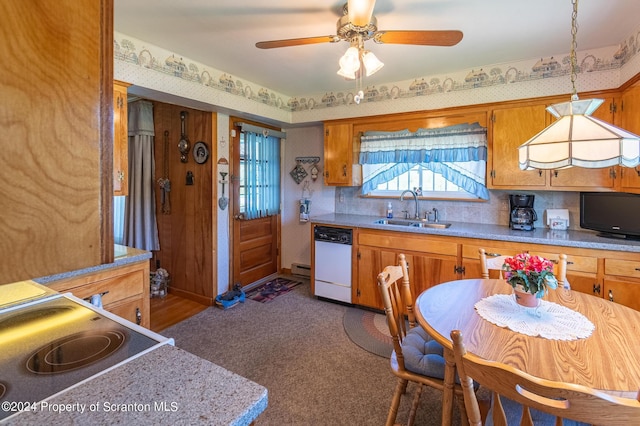 kitchen with stove, white dishwasher, ceiling fan, sink, and decorative light fixtures