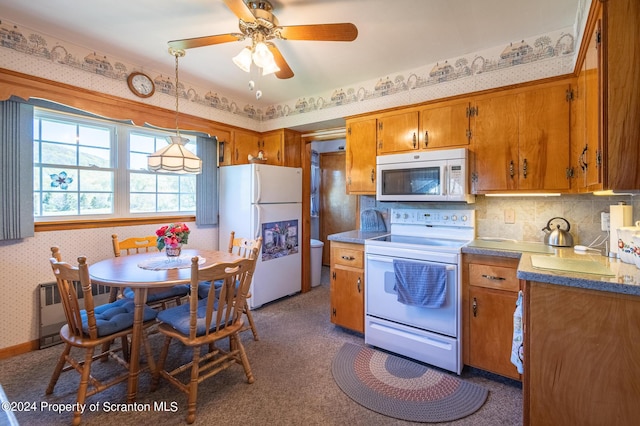 kitchen featuring decorative light fixtures, ceiling fan, white appliances, and radiator