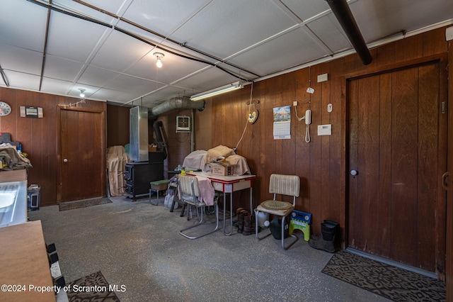 basement with heating unit and wooden walls