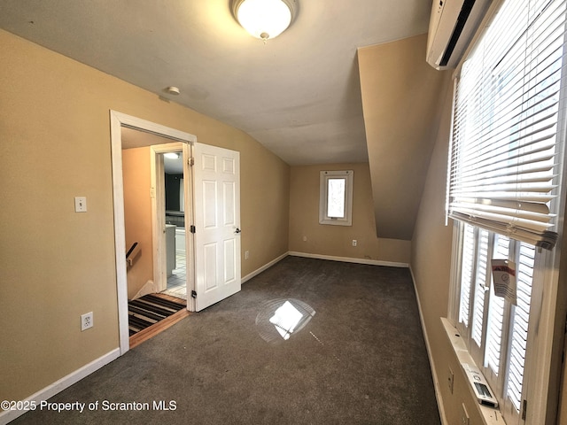 bonus room featuring baseboards, carpet floors, a wall unit AC, and vaulted ceiling