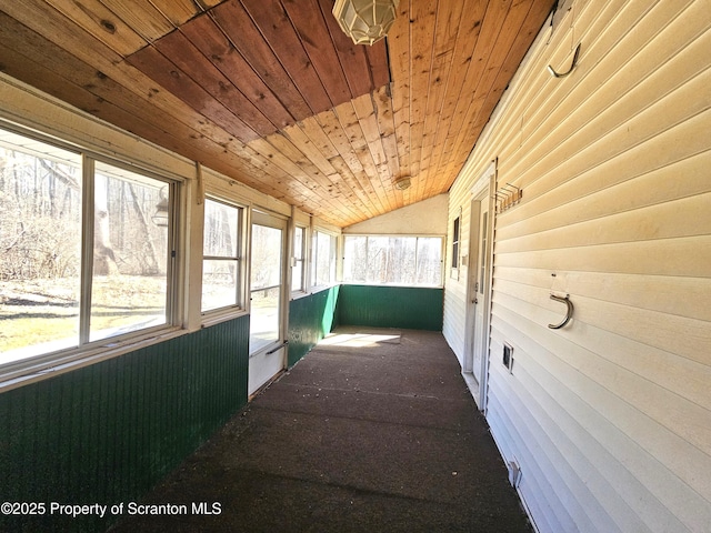 hallway featuring lofted ceiling and wooden ceiling