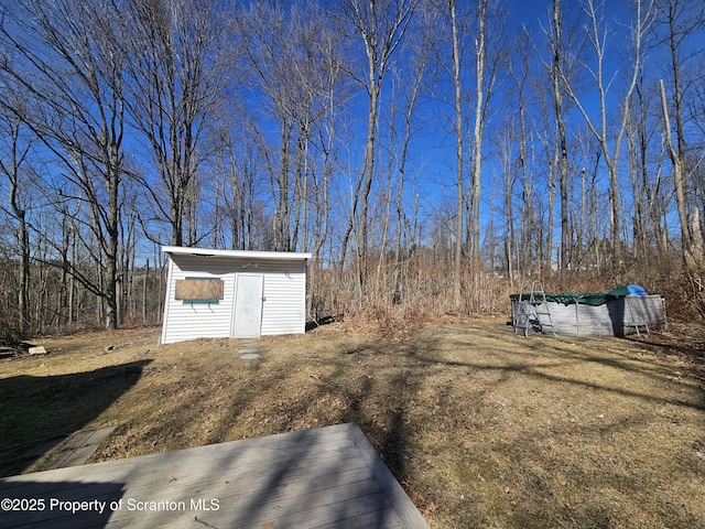 view of yard with an outbuilding and a storage shed