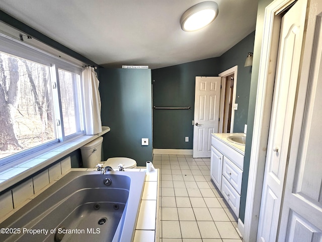 full bathroom with tile patterned floors, baseboards, a jetted tub, and vanity