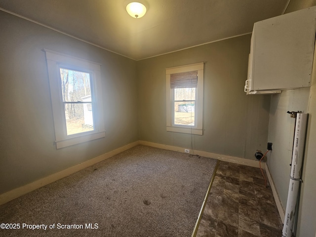 clothes washing area with baseboards