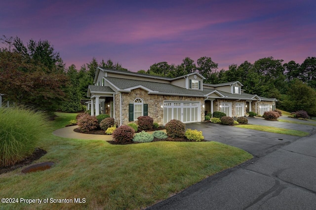 view of front of house with a lawn and a garage